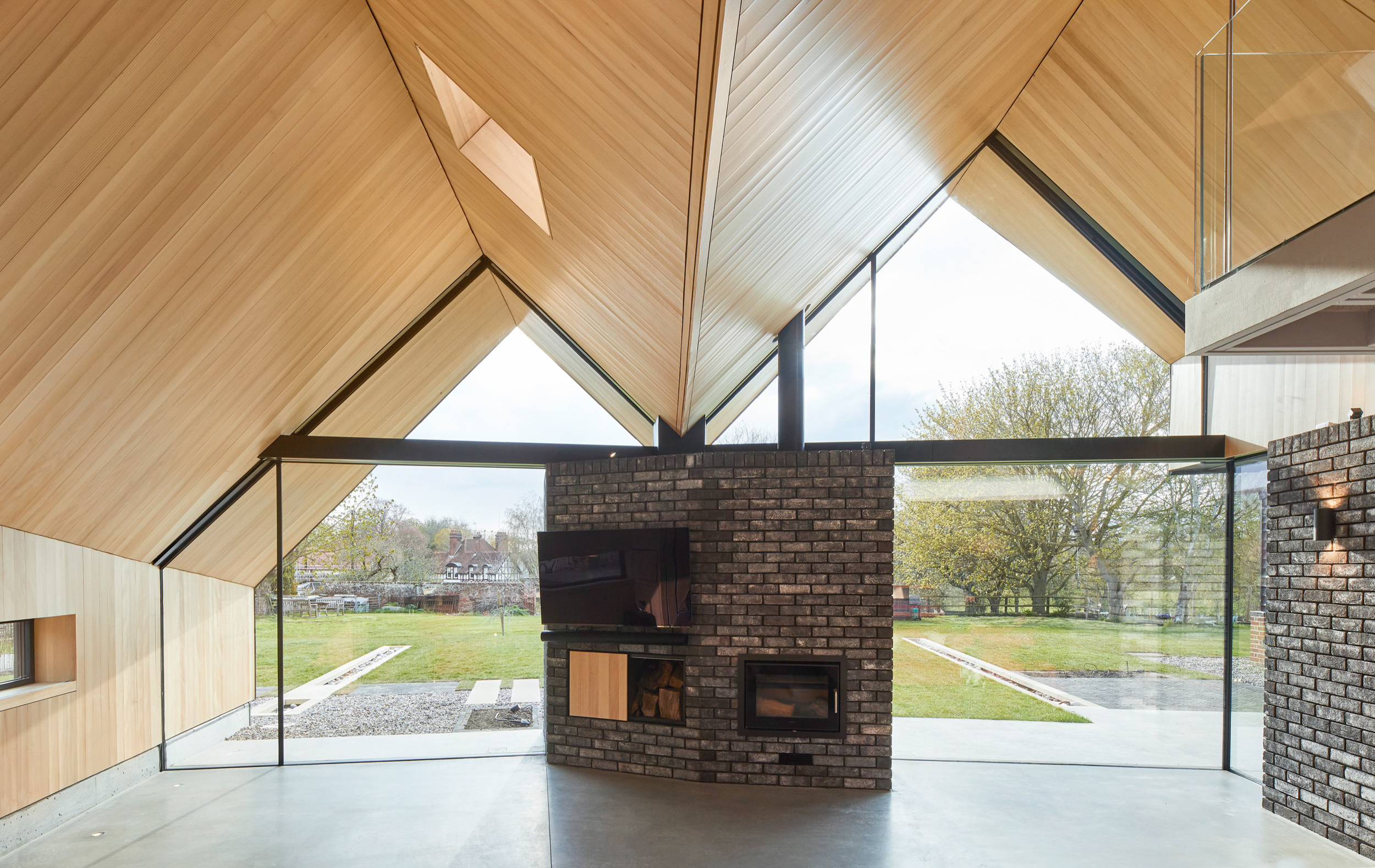 Looking out to fields from house with timber pitch roof | cdc studio cambridge architects