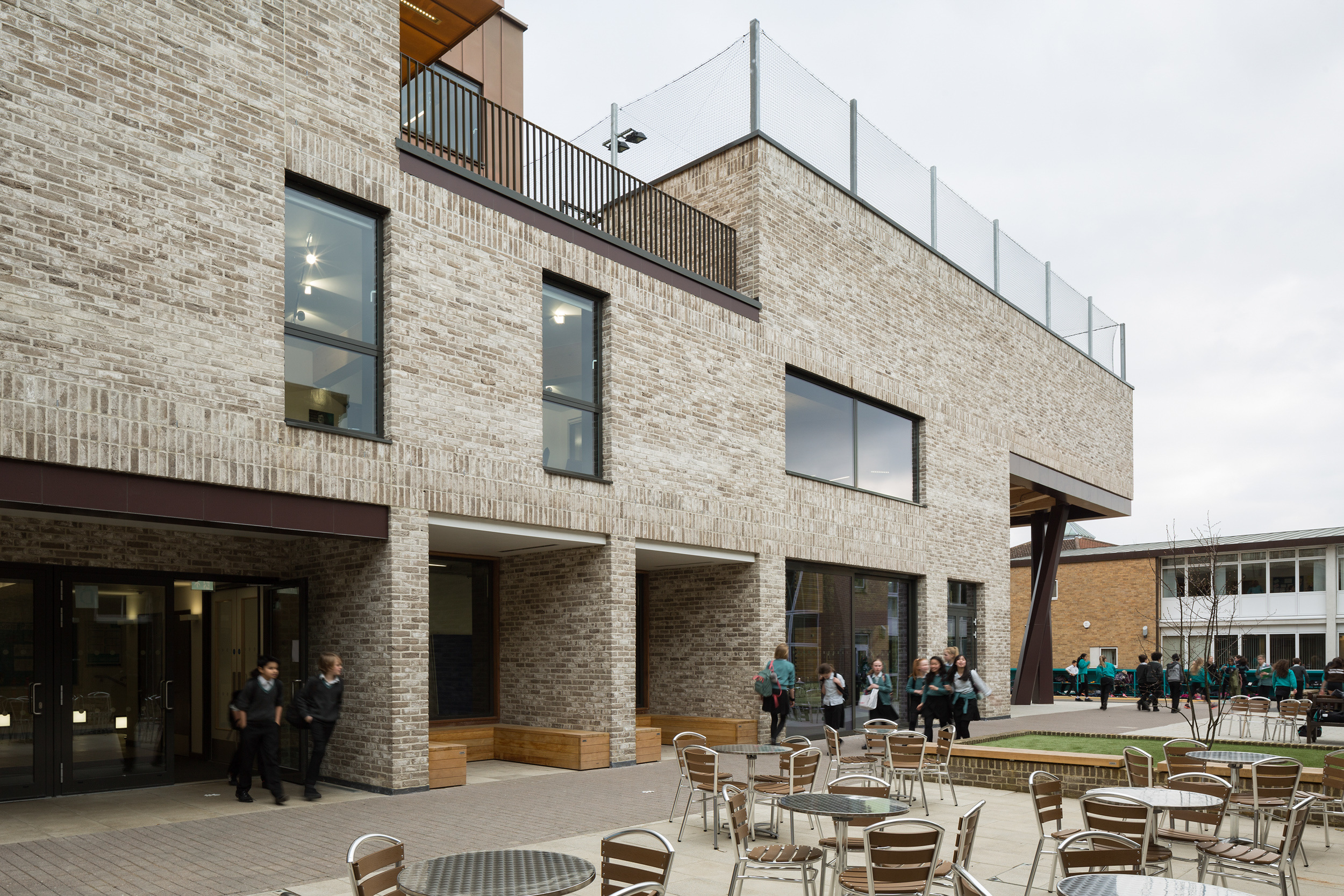 View of stephen perse foundation sports learning school entrance from outdoor seating | cambridge architects CDC studio