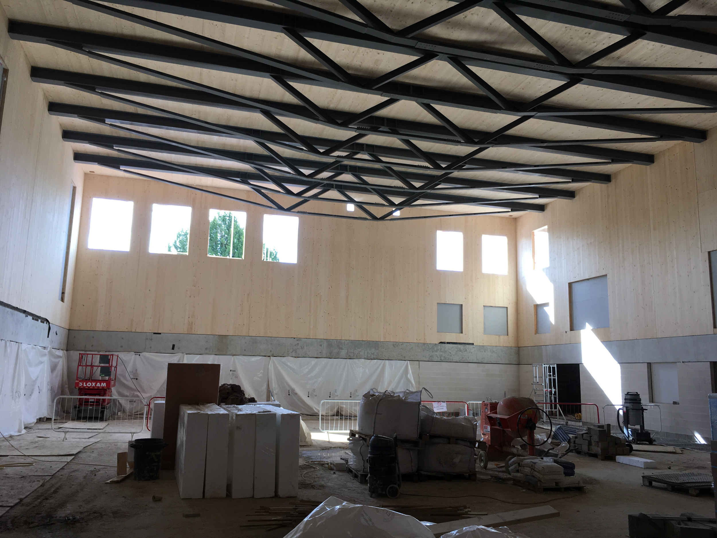 steel trusses in sports hall during construction | CDC Studio Cambridge architects
